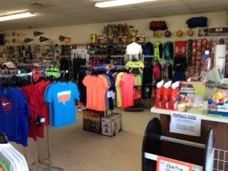 H Mickel Sports store interior showing racks of clothing and sports gear
